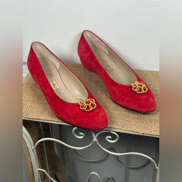 Salvatore Ferragamo red suede pumps featuring a gold-toned ornamental buckle